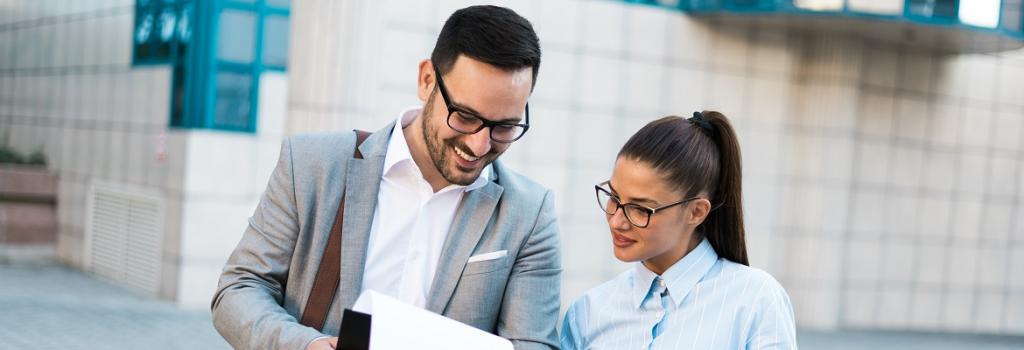 Male and female looking at documents