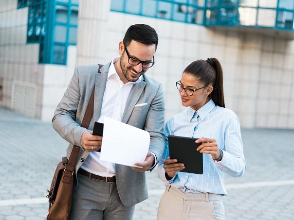 Male and female looking at documents