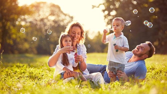 Male and female spending time with their children after a work trip