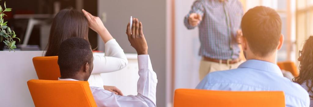 Male and female asking question in meeting