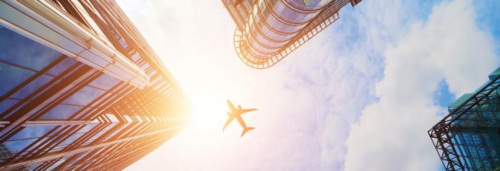 Plane flying over buildings