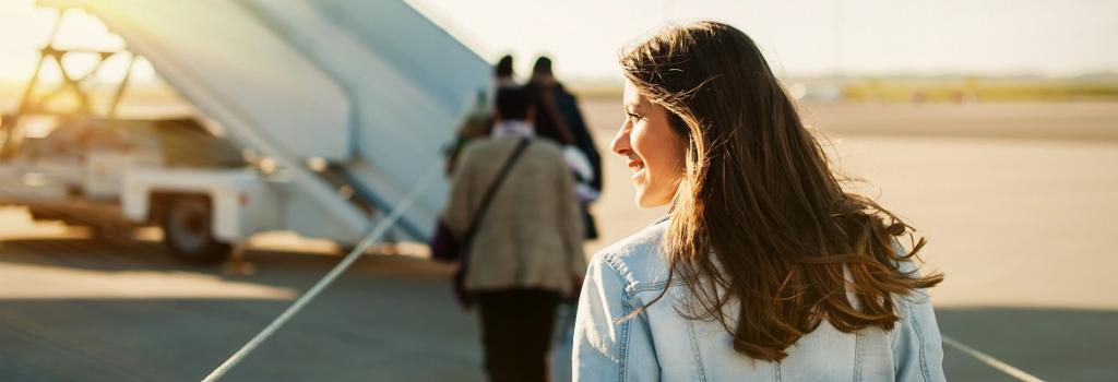 Female walking onto plane