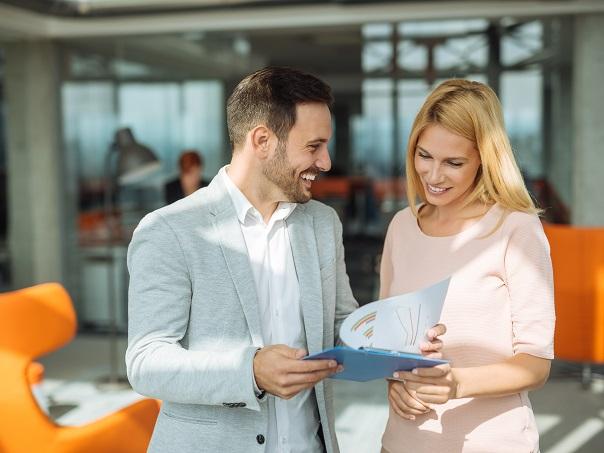 Two business professionals looking at travel expenses