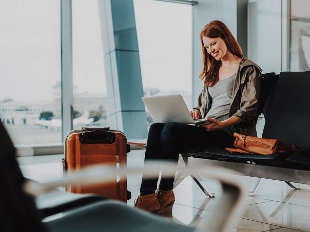 Lady on laptop at airport