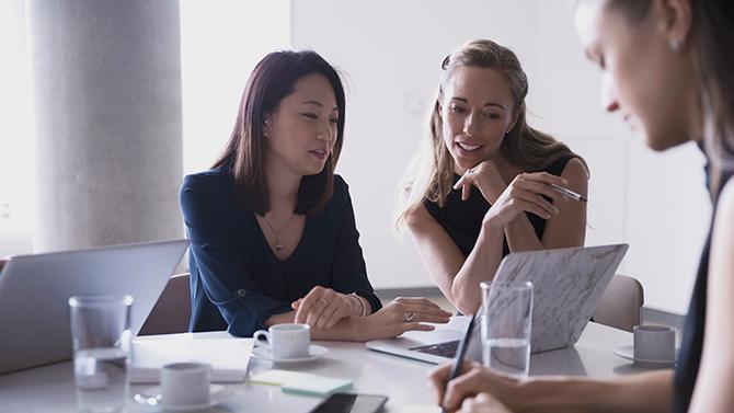 Female-Professionals-Looking-at-Laptop