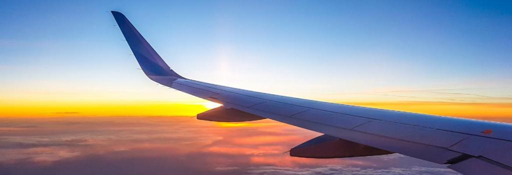 Plane flying in sunset