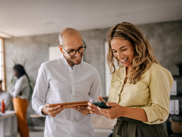 Man and lady looking at their business travel savings