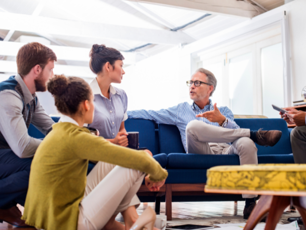 Group of travellers discussing their travel and how much they love Corporate Traveller.