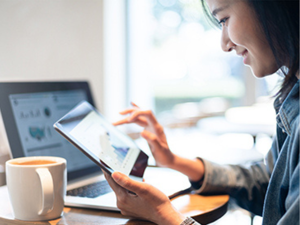 Lady looking at reporting on a tablet