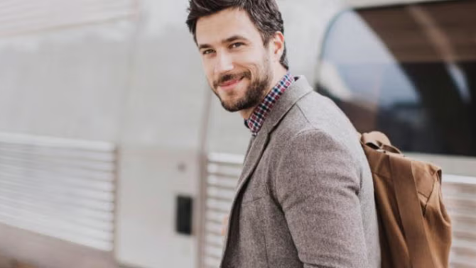 A man carrying a backpack demonstrating the benefits of packing light for business trips.